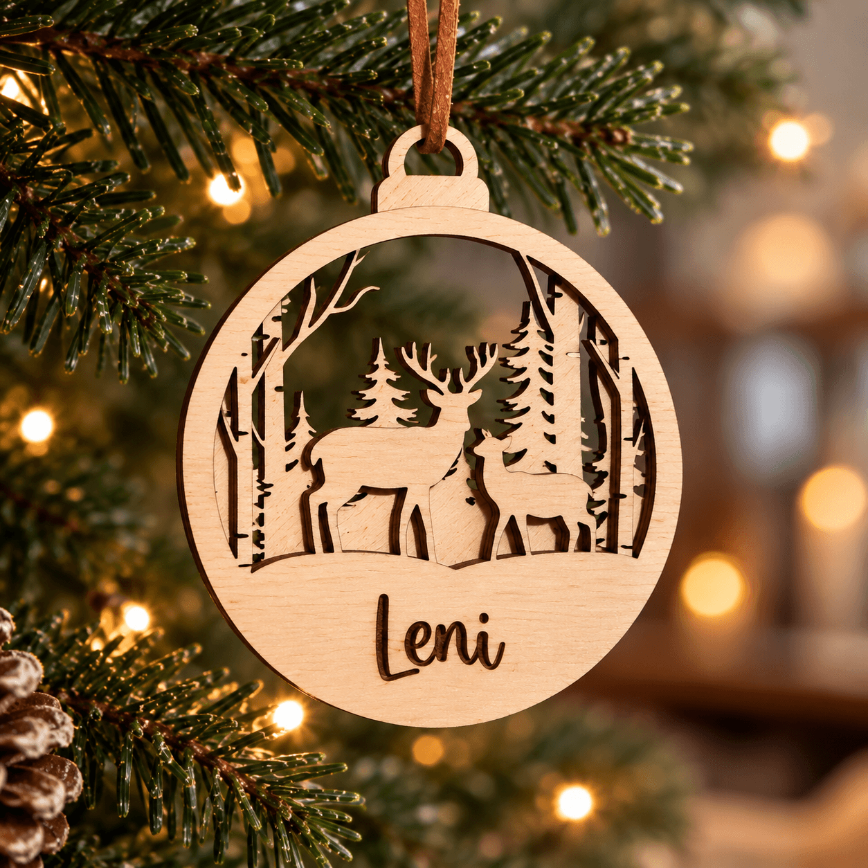 Wooden Christmas bauble with two deer in a winter forest and Leni name engraving.
